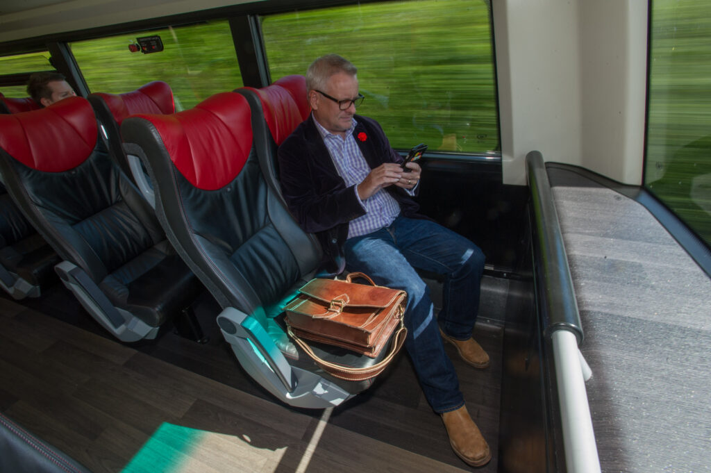 Man using Device on Bus