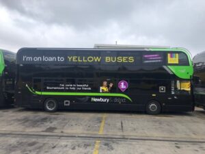 Reading buses black bus with yellow buses writing