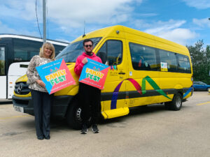 yellow minibus with yellow bus staff stood in front