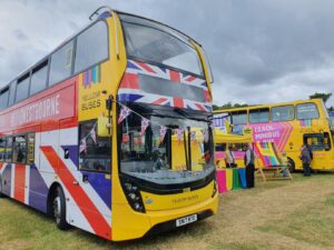 pic of yellows buses bus with bunting at rally